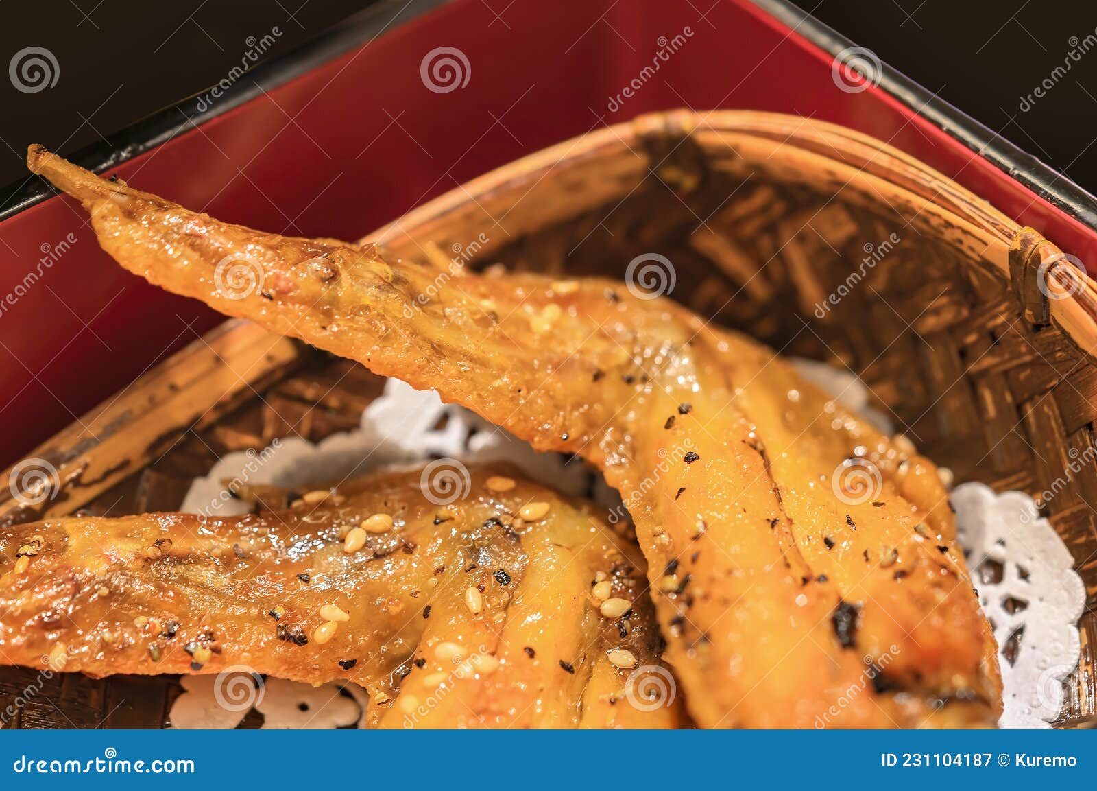 japanese deep fried chicken wings called tebasaki serving in a temi woven bamboo winnowing basket.