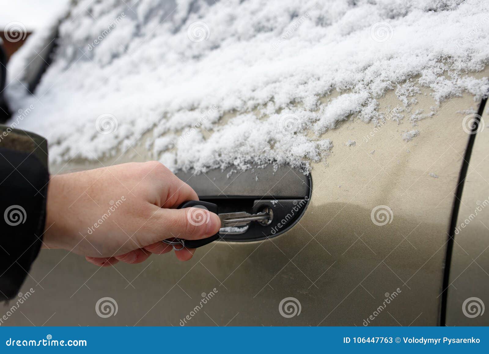 Close Up Of A Key Inserted Into The Lock Of Frozen Car Door