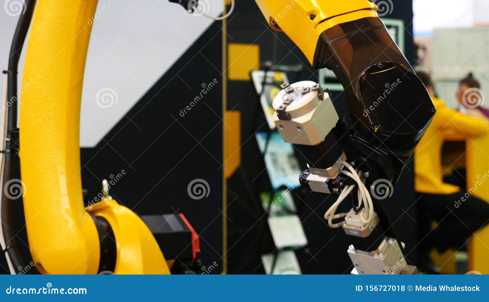 Closeup of Large Yellow Robot Machine Hand Installing Some Electrical