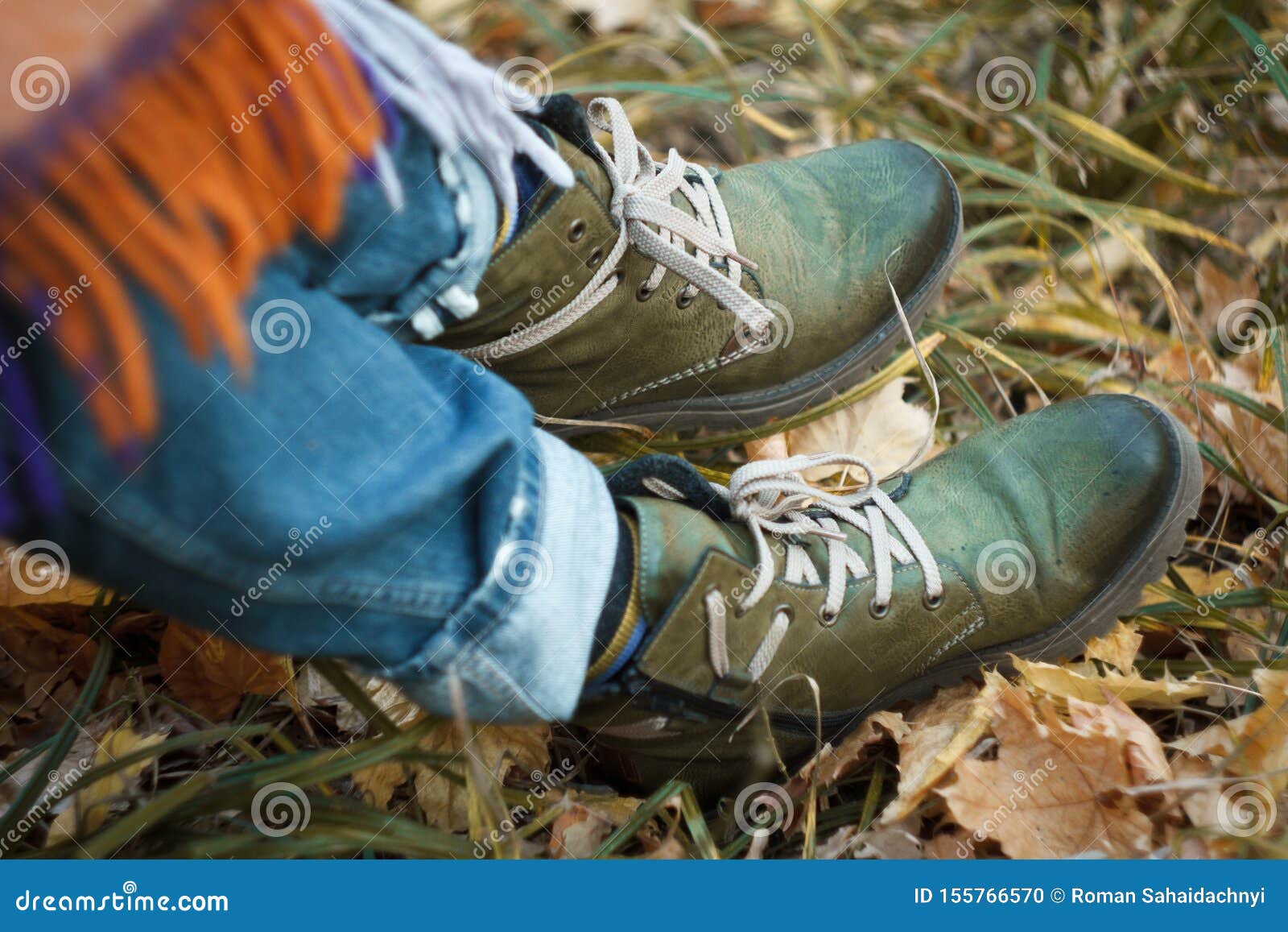 Close-up Of A Leg In Green Hiking Boots 