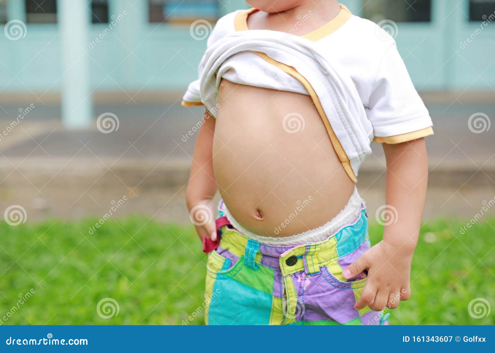 Close Up Little Boy Lifting His Shirt Show Exposing His Big Tummy