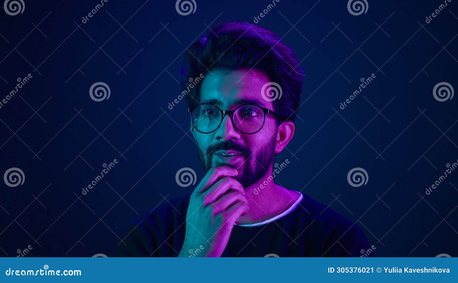 close up male portrait in neon studio ultraviolet background blue backdrop arabian muslim shocked amazed guy astonish