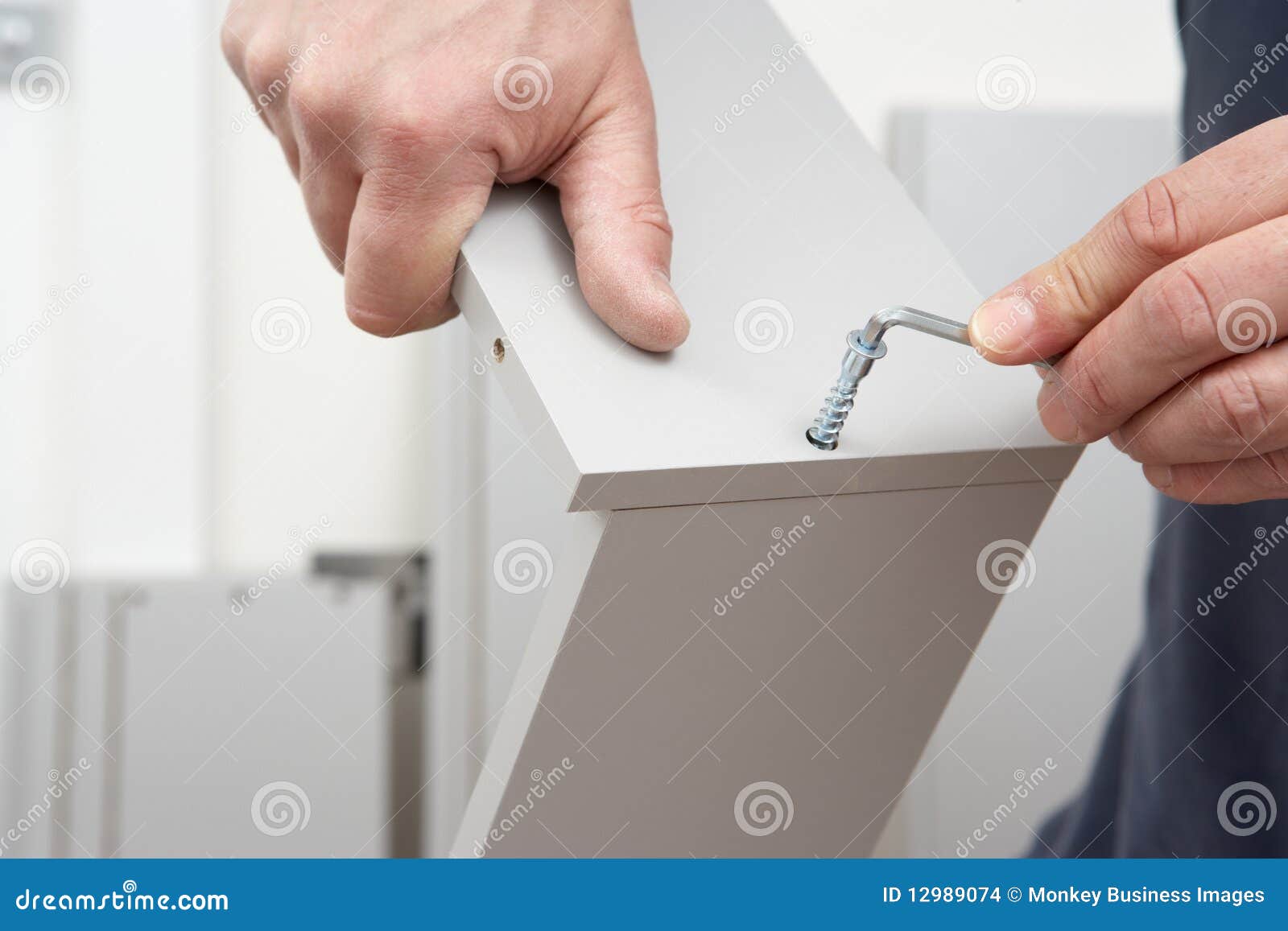 close up of man assembling flat pack furniture