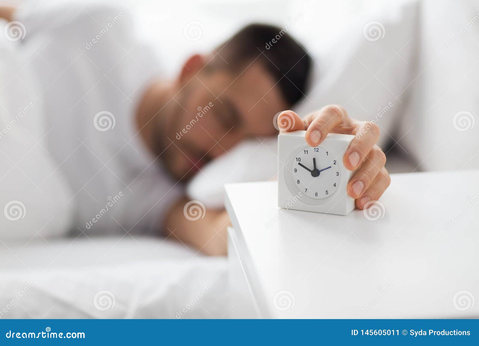 Close Up Of Man In Bed Reaching For Alarm Clock Stock Image Image Of