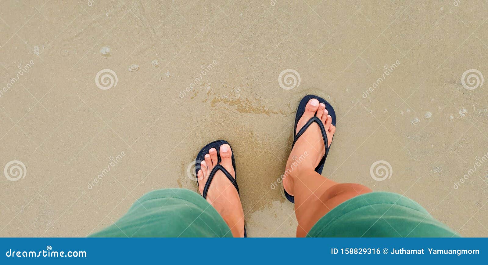 Close Up of Man in Black Slippers Feet Standing at the Beach, with a ...