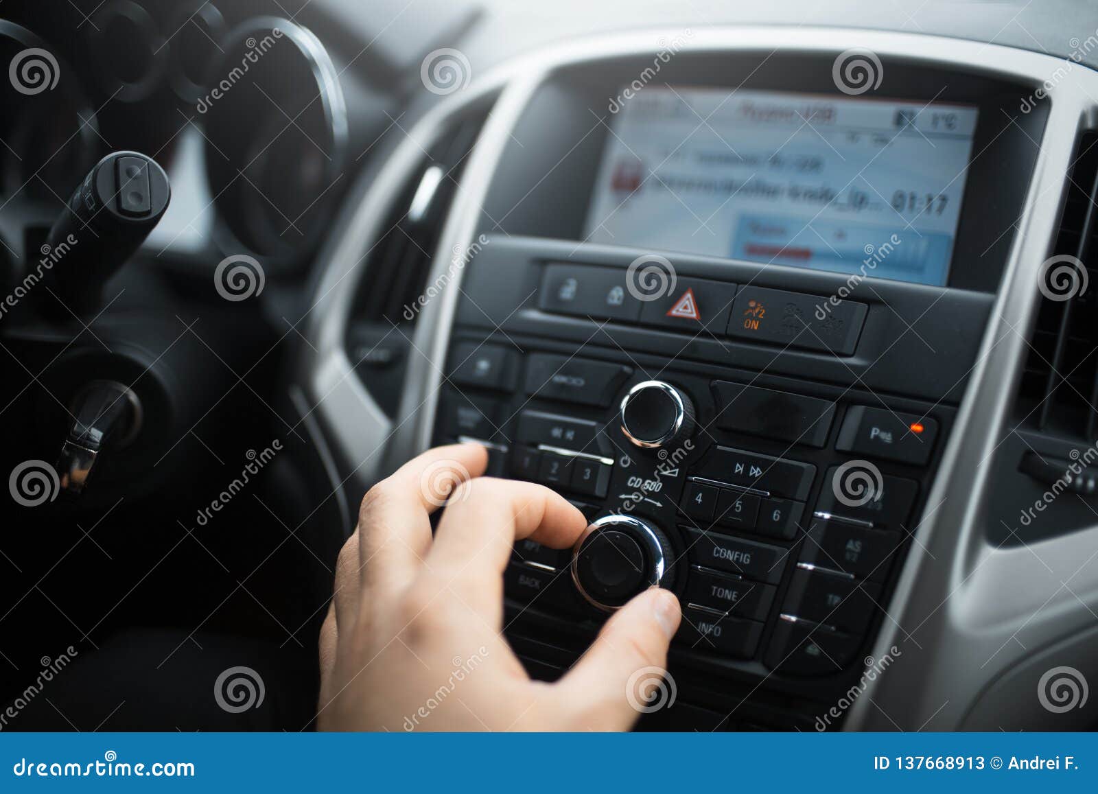 Closeup of Man Hand Adjusts the Volume Control of Car Audio System