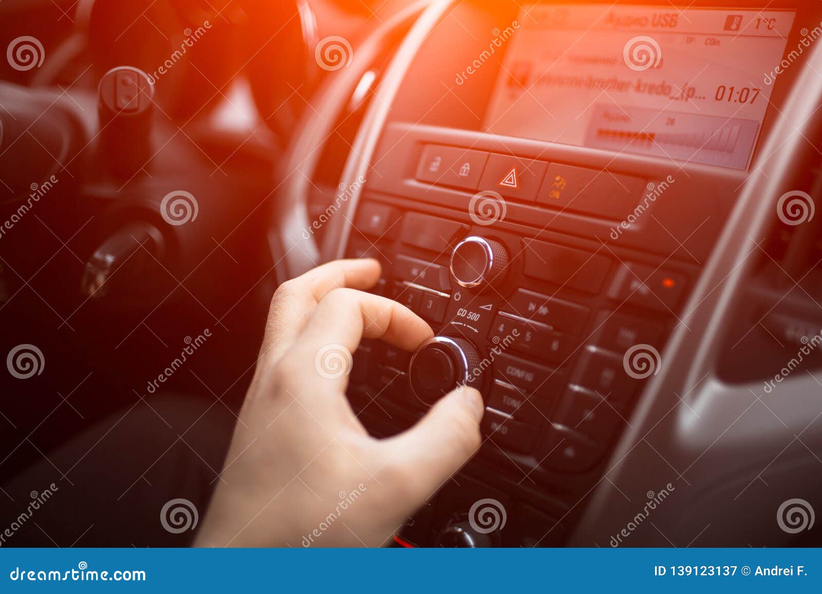 Closeup of Man Hand Adjusts the Volume Control of Car Audio System