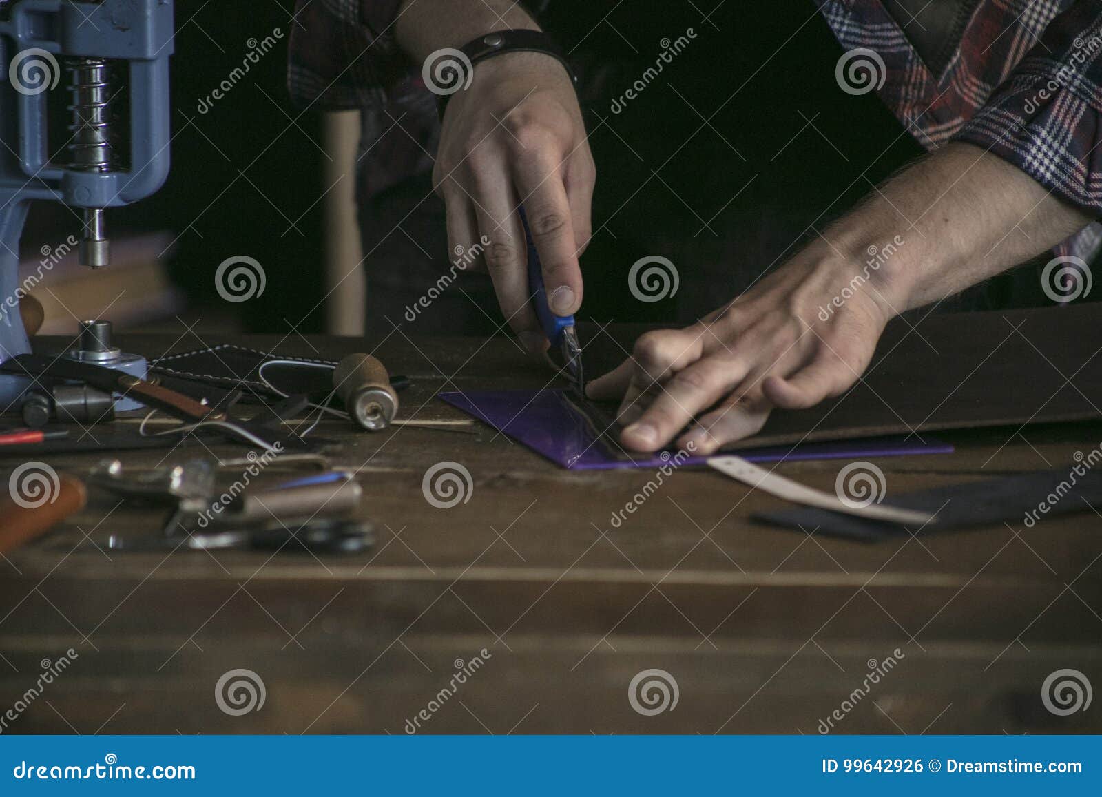 Close Up of Man Hand Leather Maker Working on Wooden Table with Tools