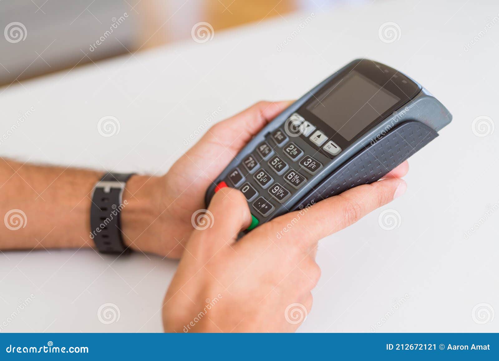 close up of man hands holding point of sale terminal, dataphone for shopping paying using credit card