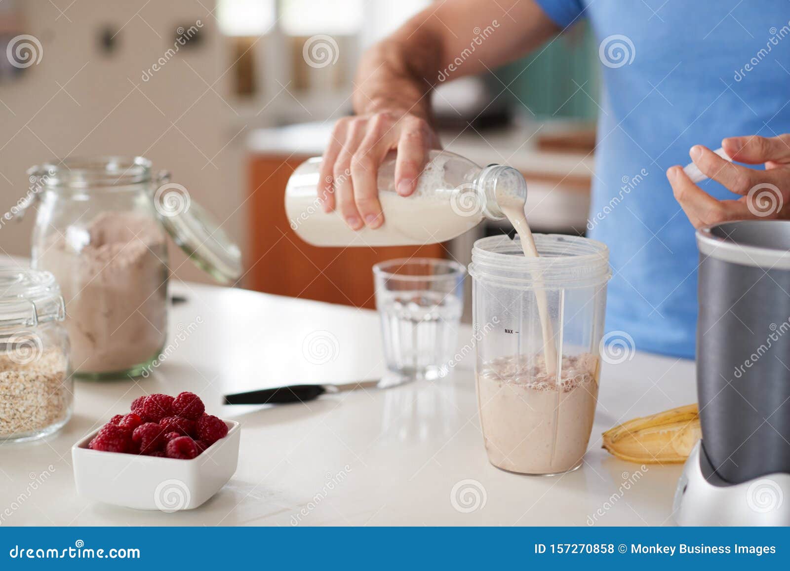 close up of man making protein shake after exercise at home