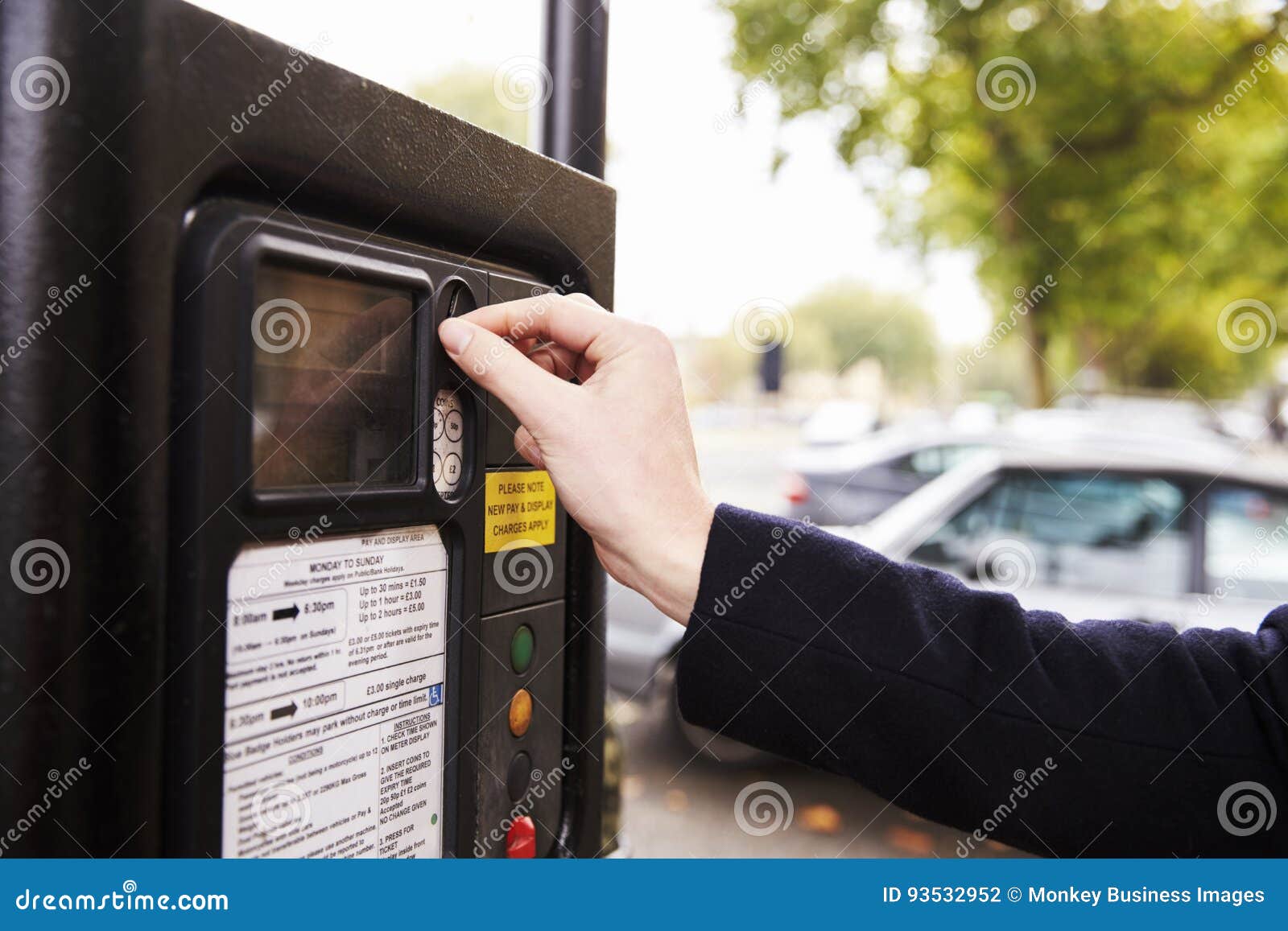 Close Up of Man Putting Money in Parking Meter for Ticket Stock Photo