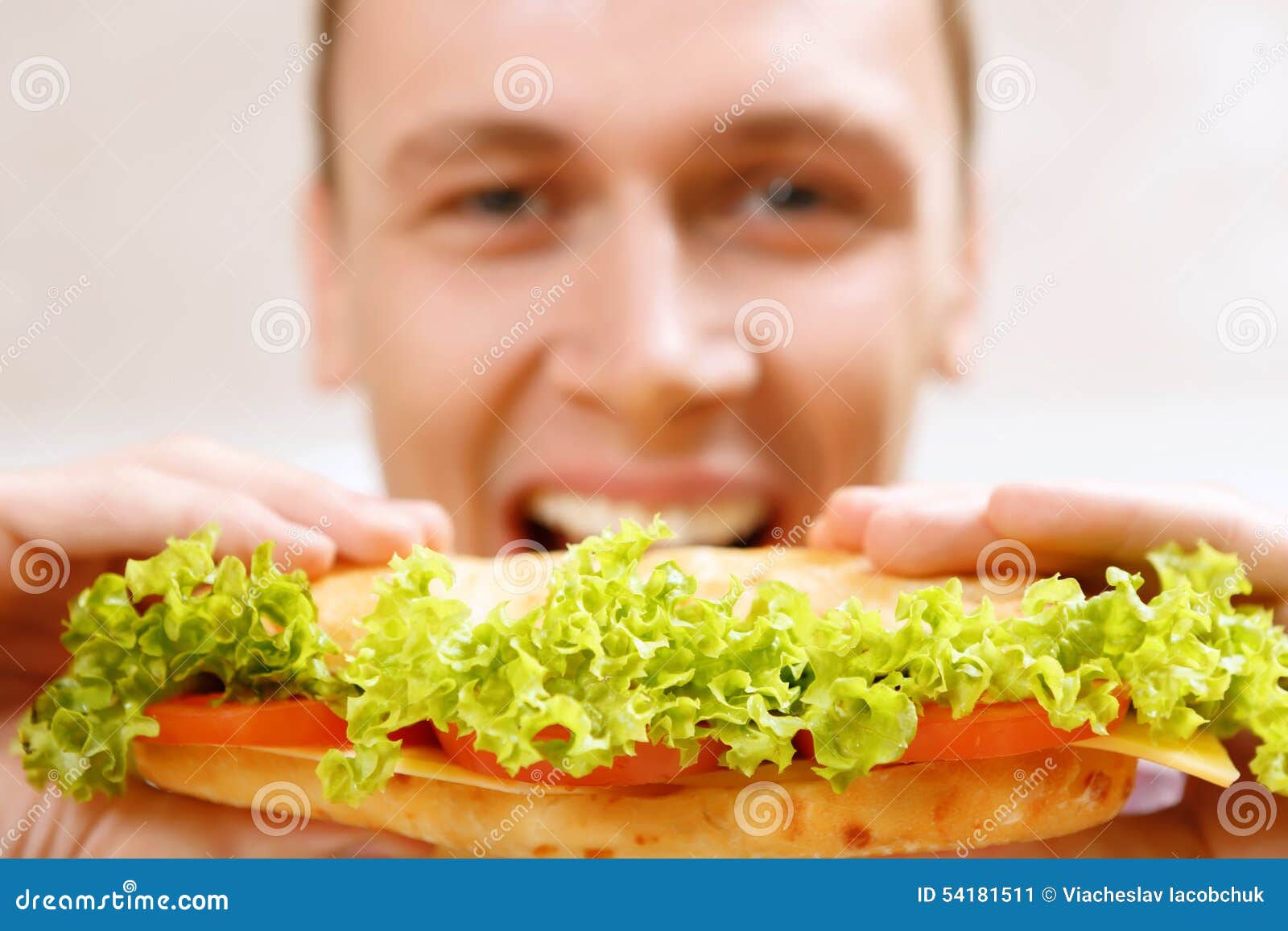 close up of man taking bite sandwich
