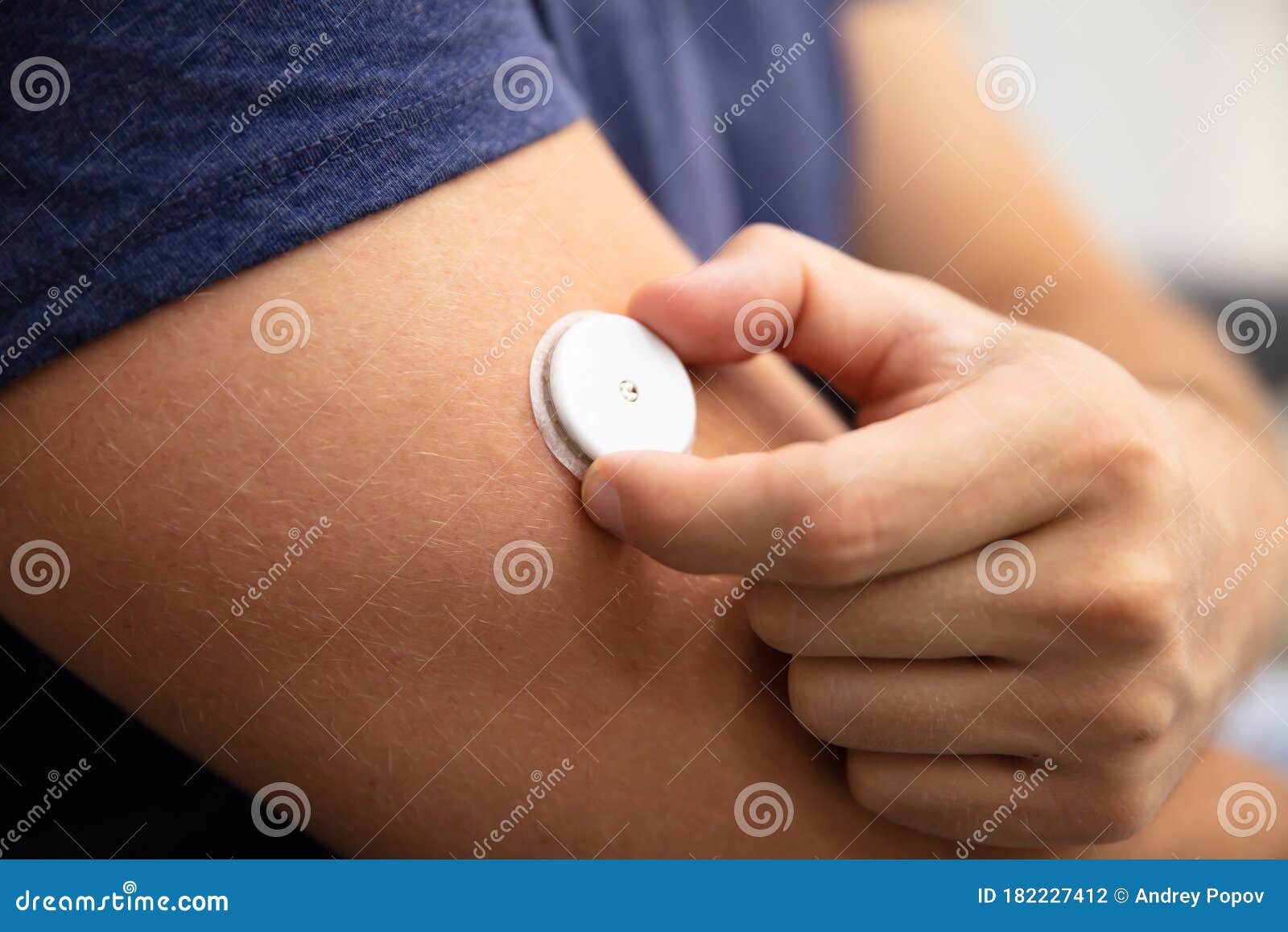 man testing glucose level with a continuous glucose monitor