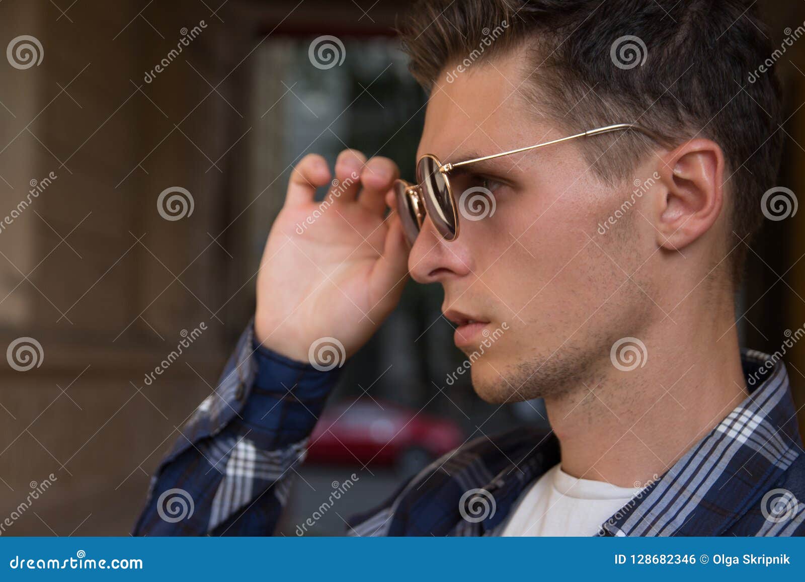 Close Up Of A Man Who Takes Off His Sunglasses Male Portrait In Profile Where He Holds Glasses