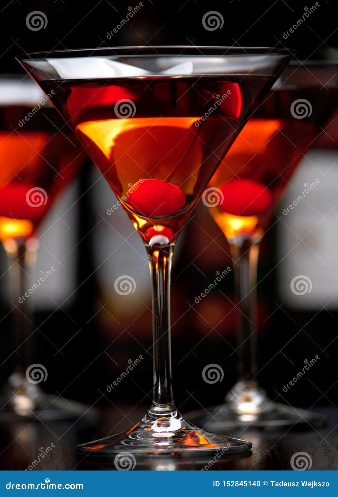 Closeup Manhattan Drinks With Cherry With Bar In The Background Stock