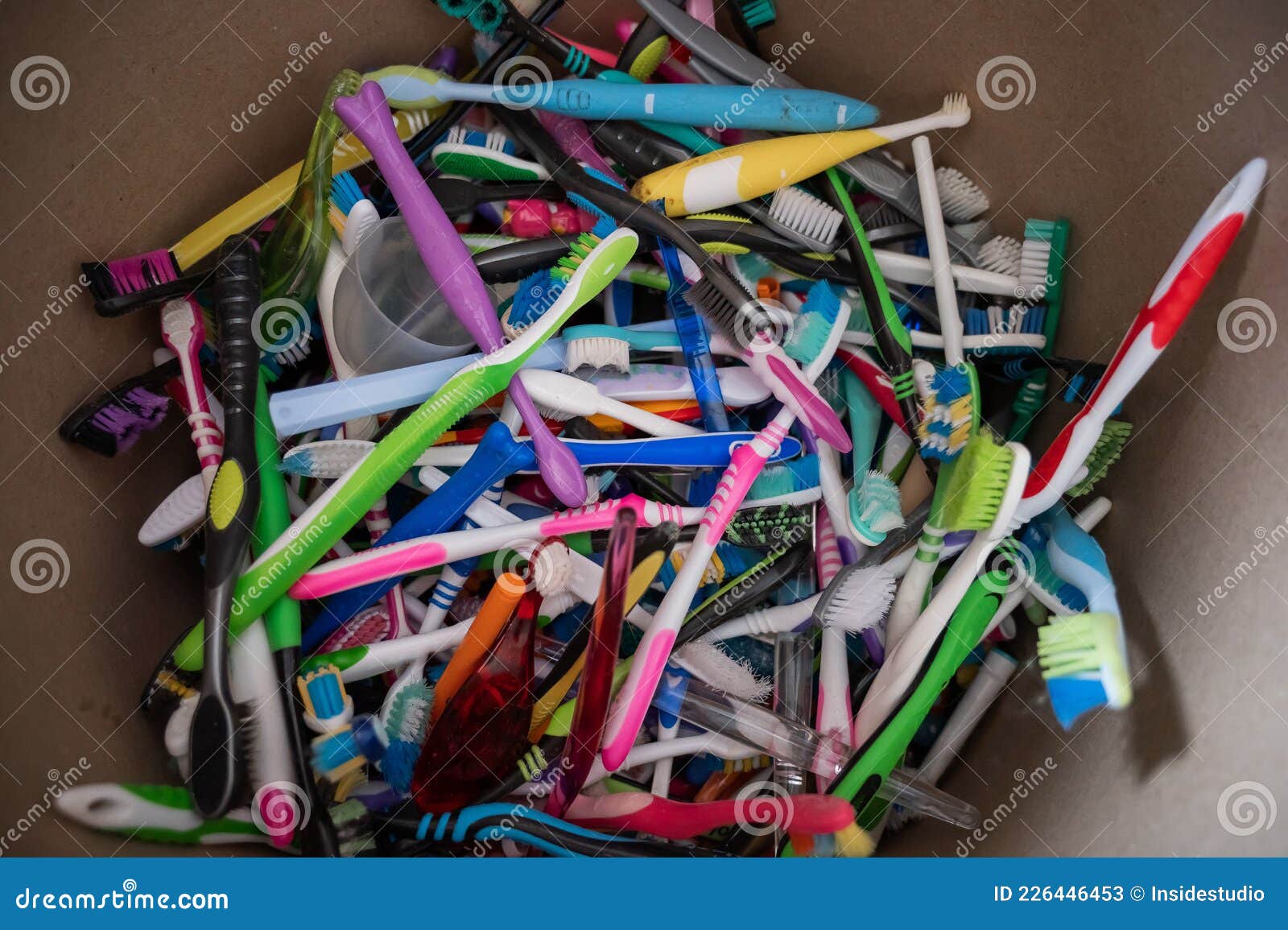 A Closeup of Many Used Plastic Toothbrushes Collected for Recycling