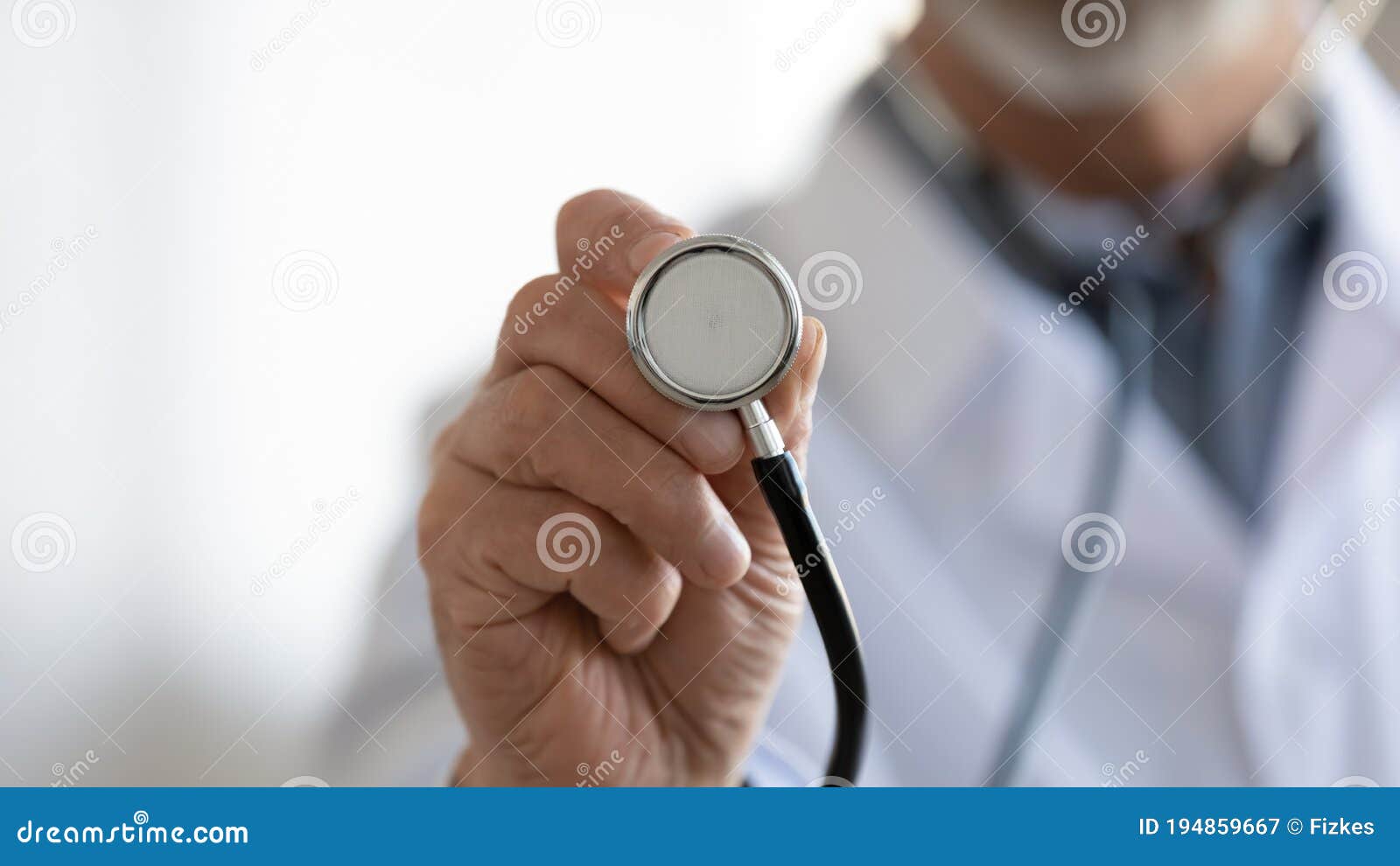close up mature doctor holding stethoscope, medical checkup