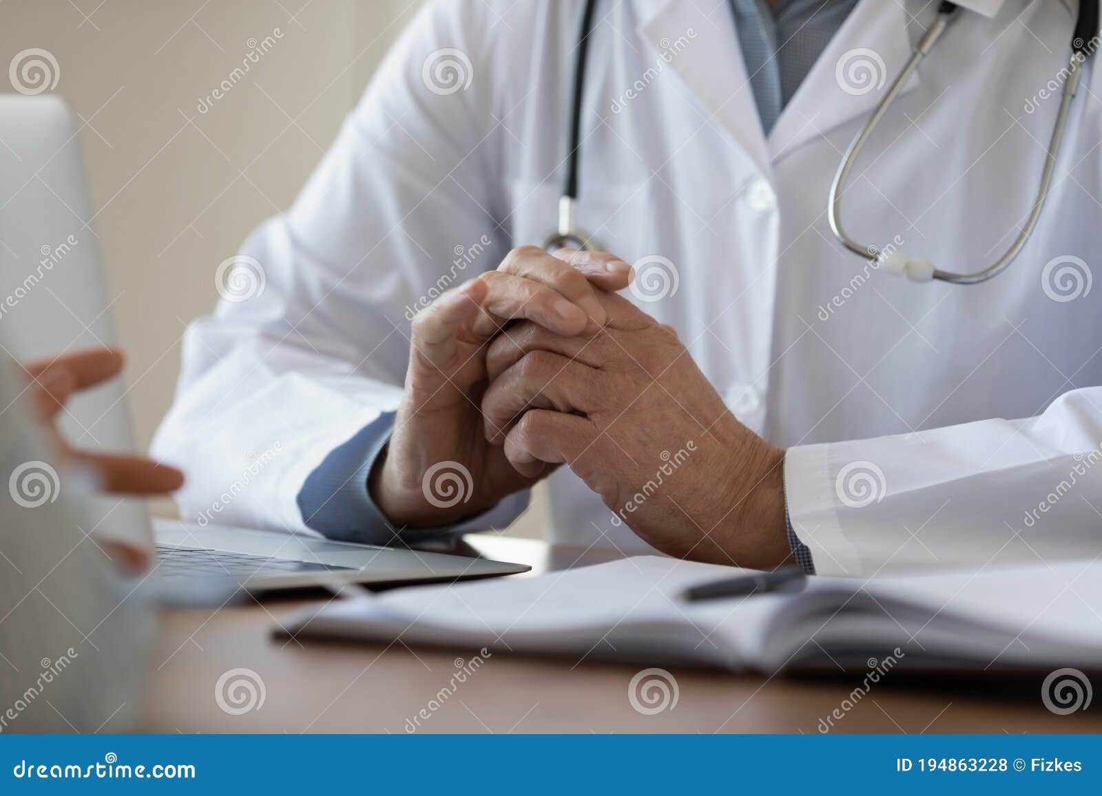 close up mature doctor listening to patient complaints at meeting