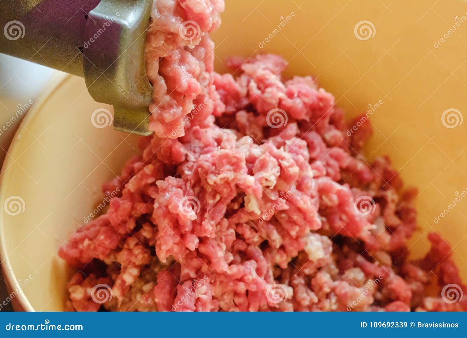 Close Up Meat Grinder or Mincingmachine with Mincemeat in. Showing the