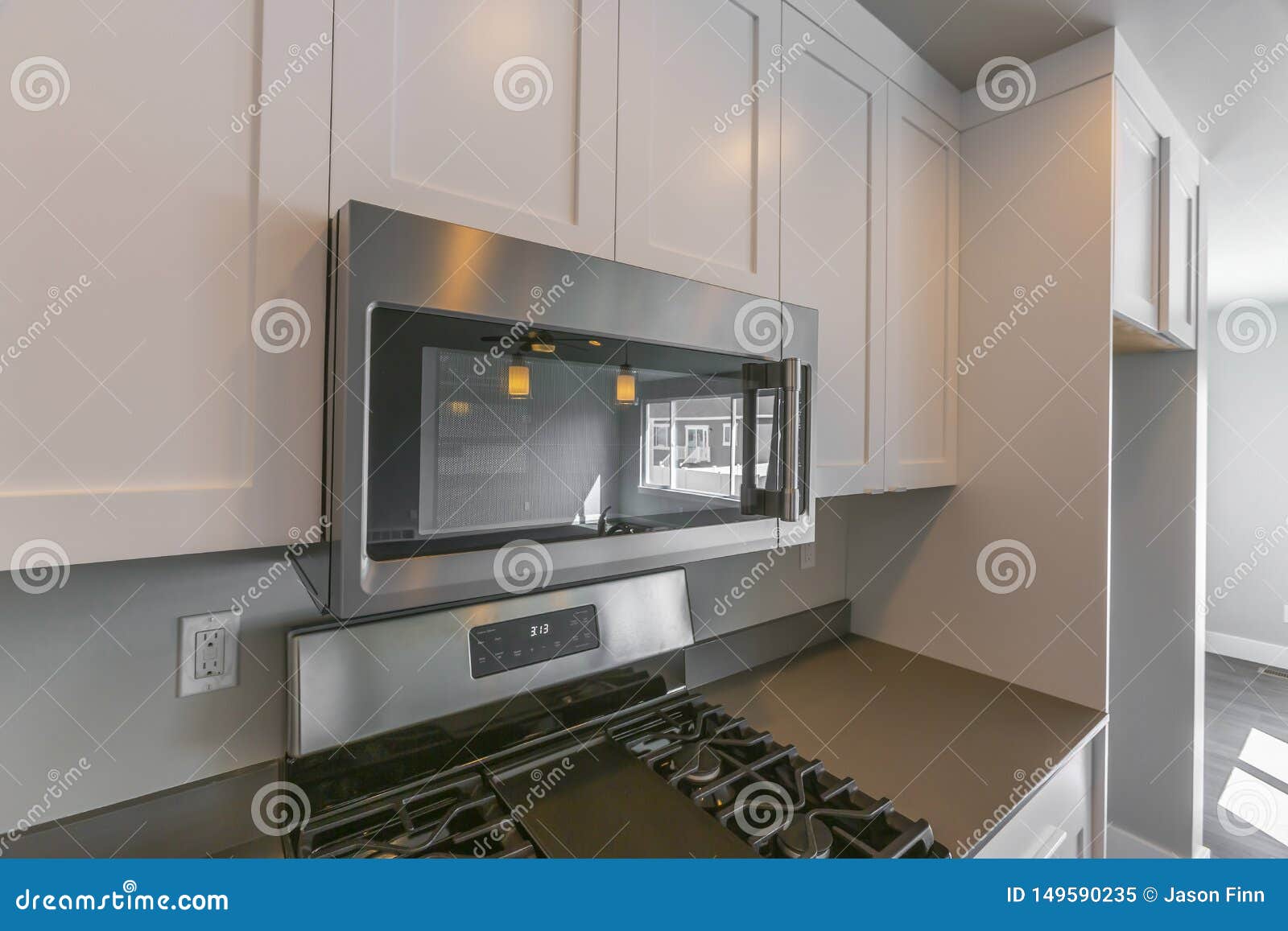 Close Up Of The Microwave And Wooden Cabinets Mounted On The Wall