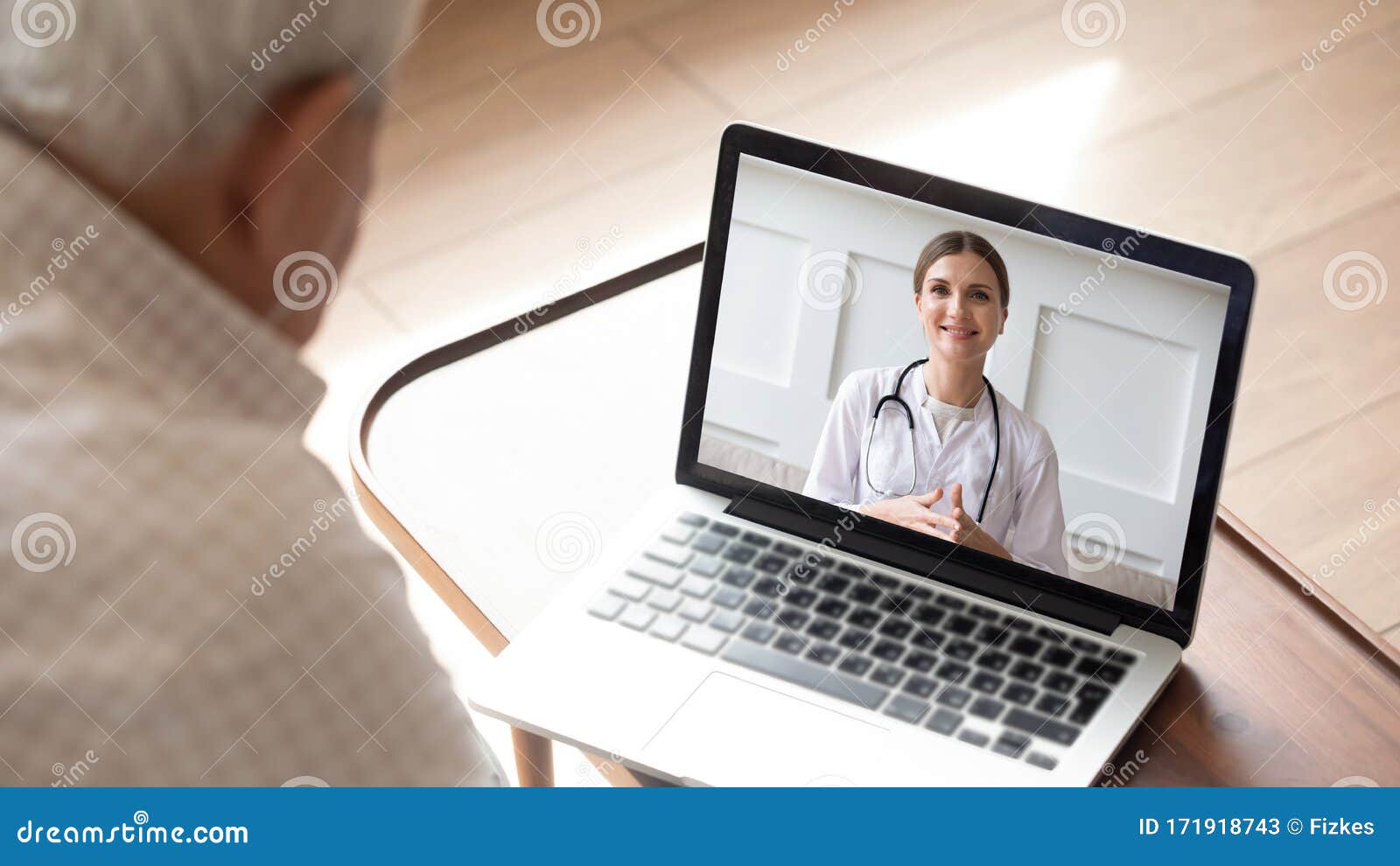 elderly man having online video consultation with doctor