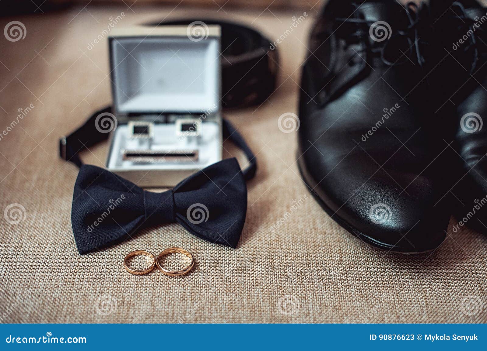 Close Up of Modern Man Accessories. Wedding Rings, Black Bowtie