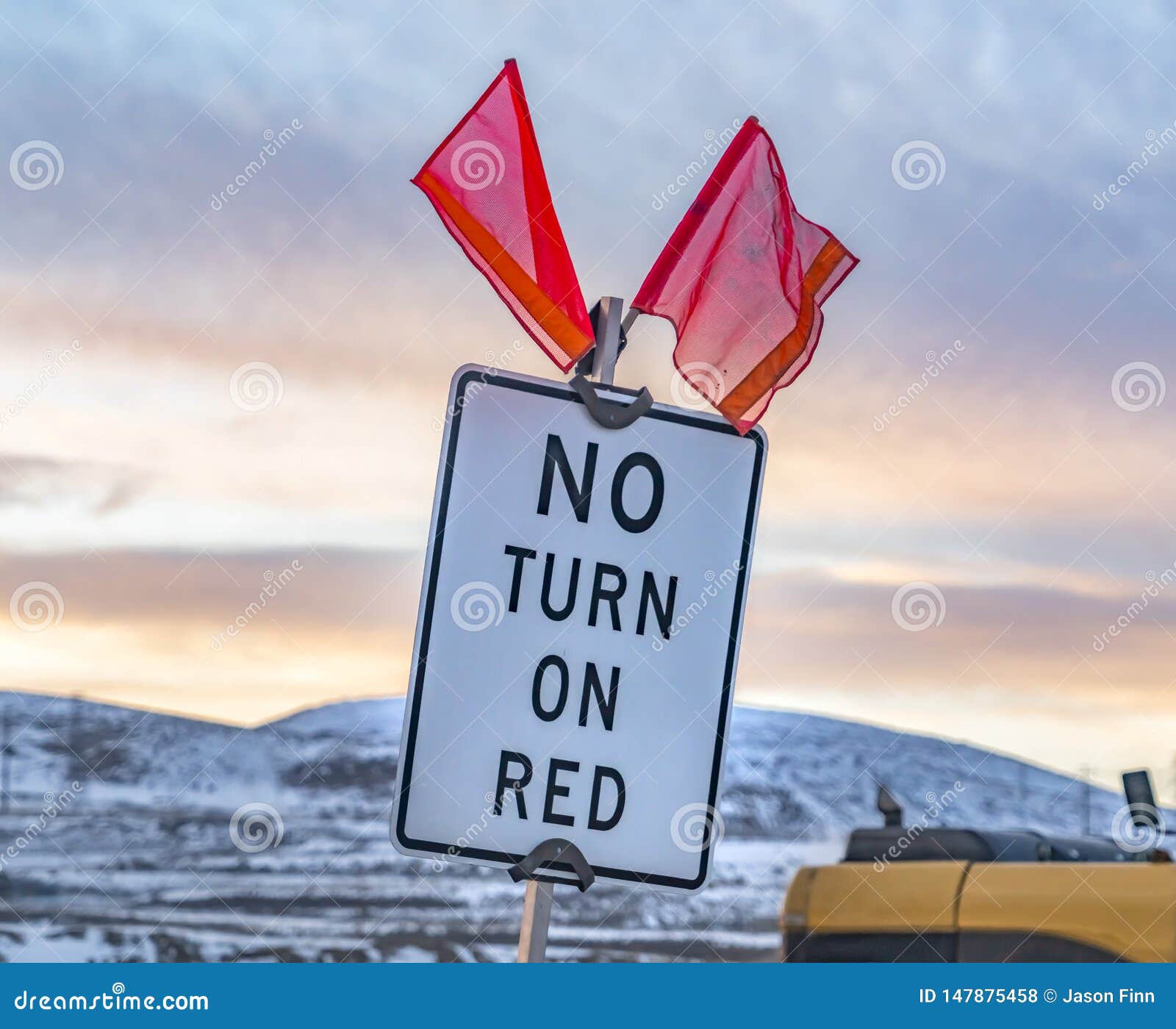 Close Up of a No Turn on Red Sign with Red Flags on Top Stock Photo