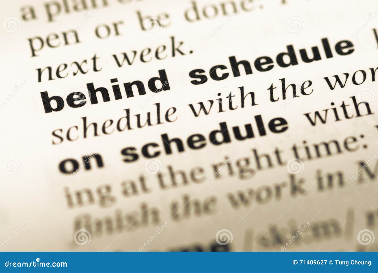 Close Up of Old English Dictionary Page with Word Behind Schedule Stock