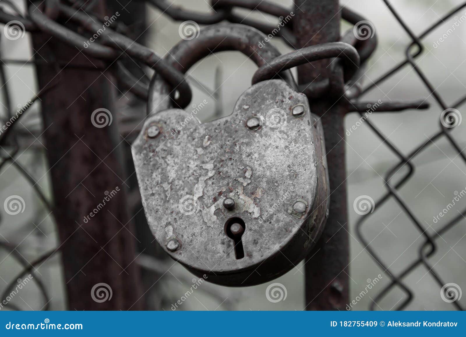 A Close-up Of An Old Locked Iron Lock With Traces Of Paint On A Thick ...
