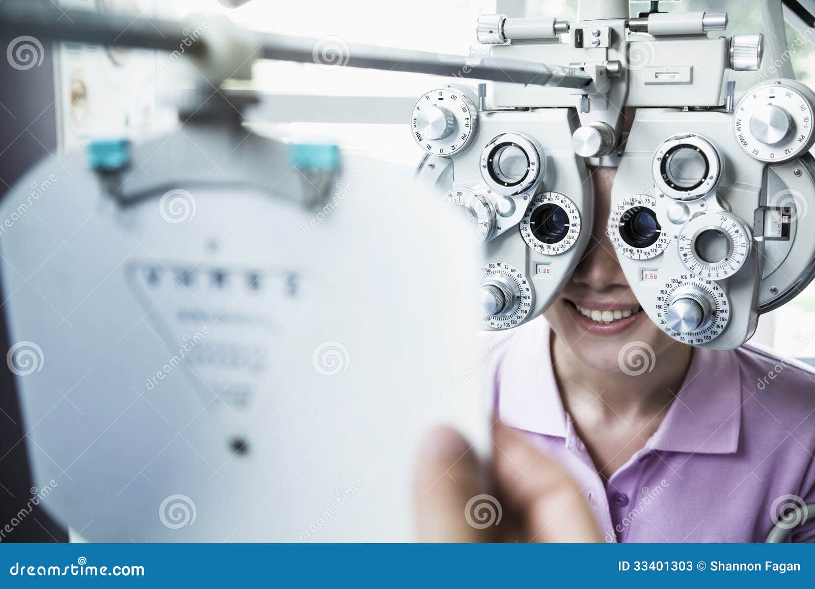 close-up of optometrist doing an eye exam on young woman