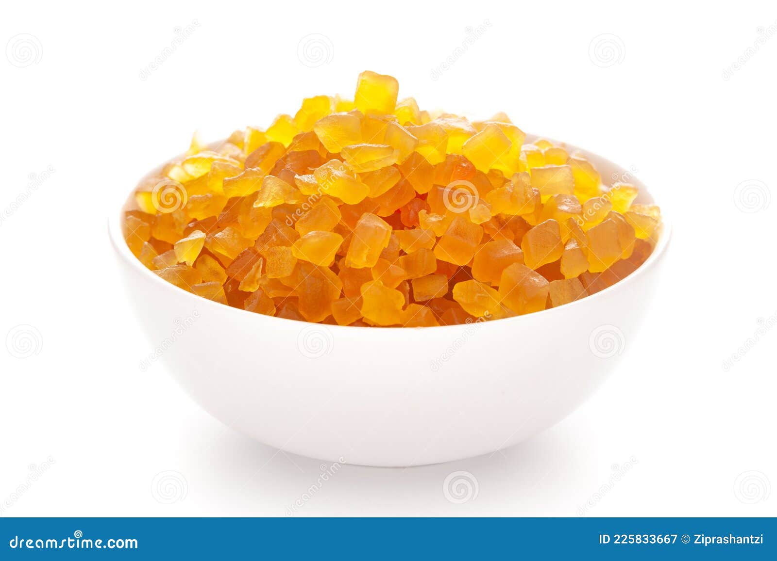 close-up organic yellow tutti frutti sweet soft candy  in white ceramic  bowl on white background