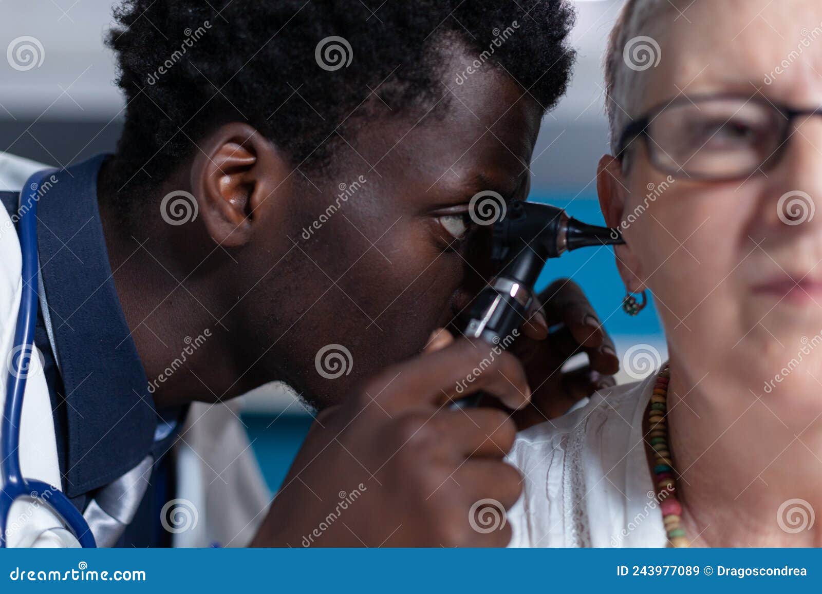 close up of otology specialist examining ill elderly patient while using otoscope