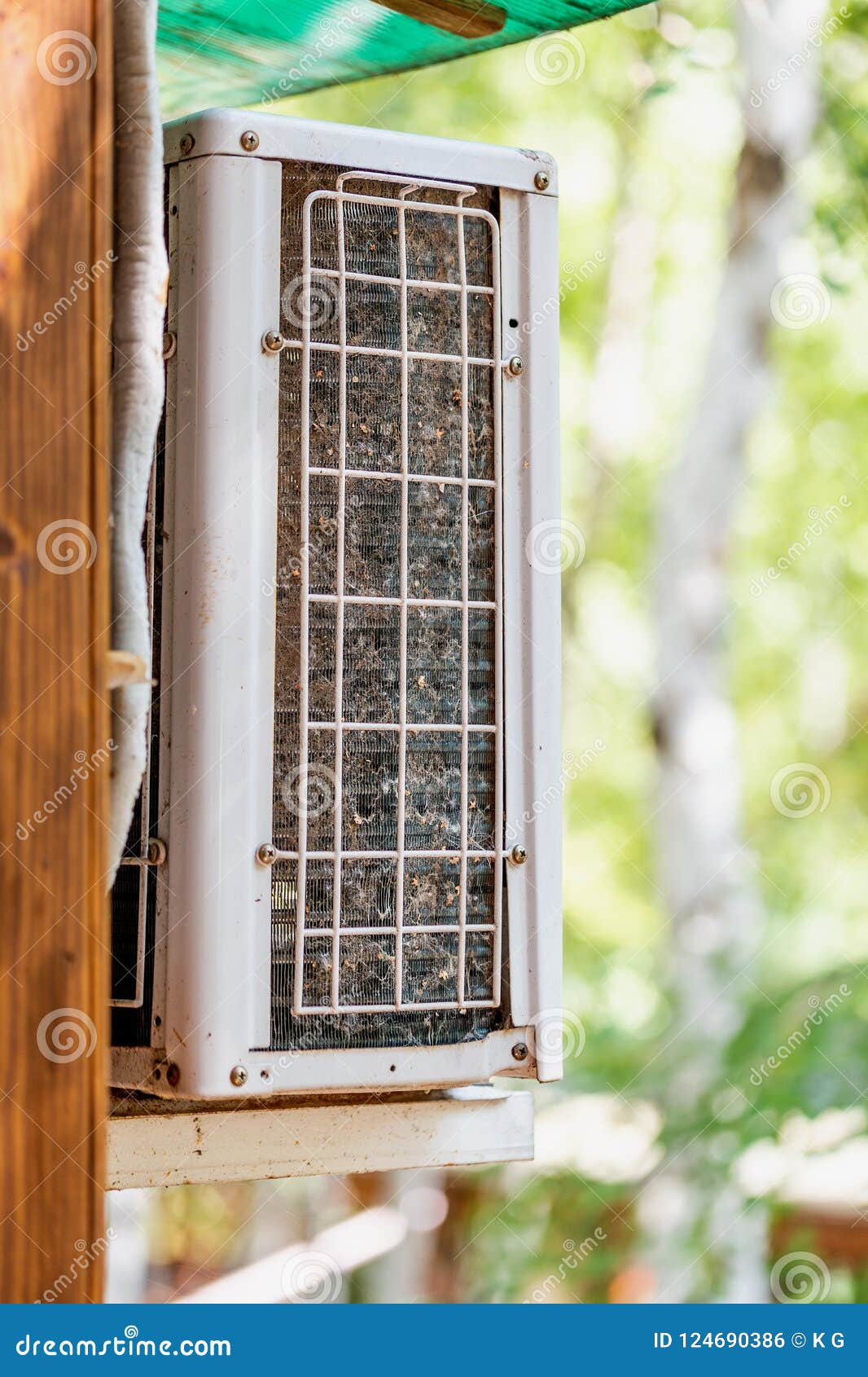 close-up outdoor air condition unit with clogged obstructed compressor radiator grill. details of air conditioner needed