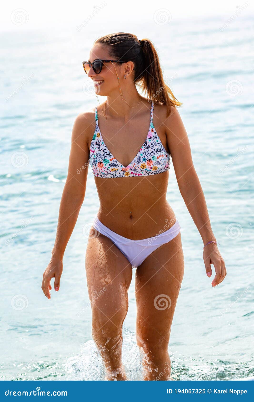 Attractive Young Woman in Bikini Walking Out of Water Stock Image