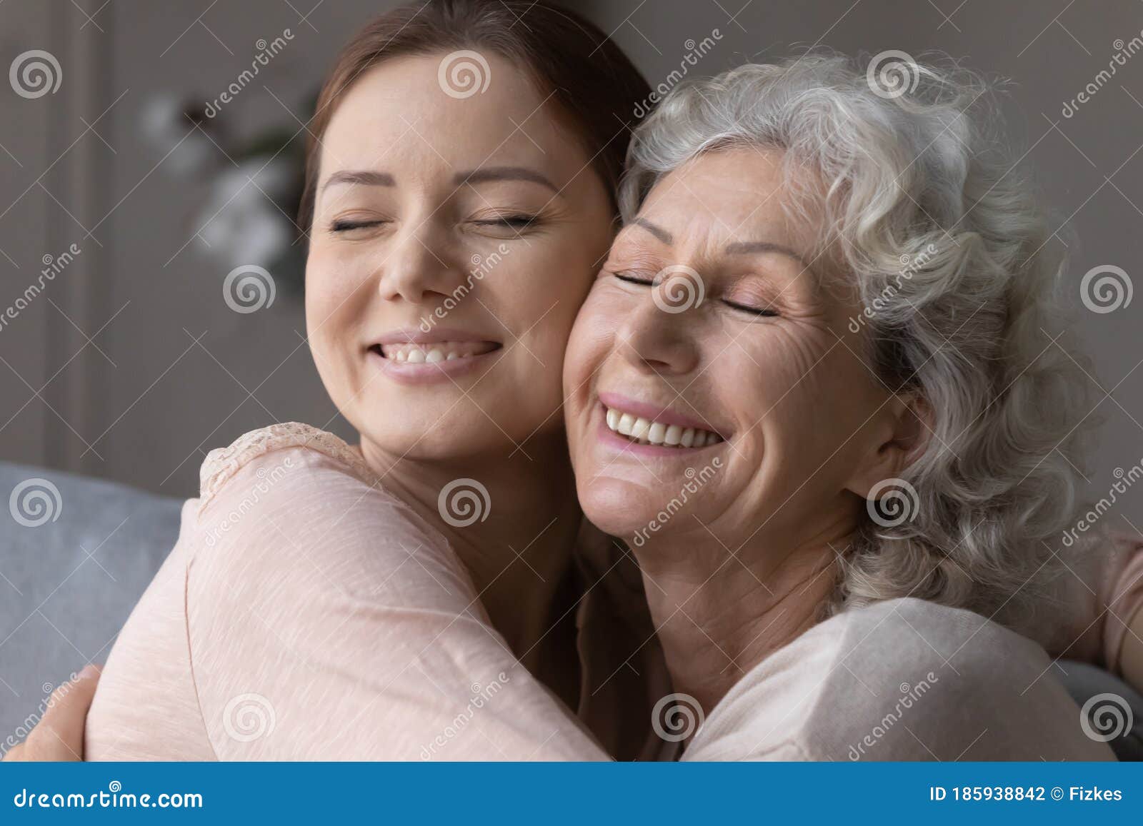 happy elderly mother and senior daughter hug and cuddle