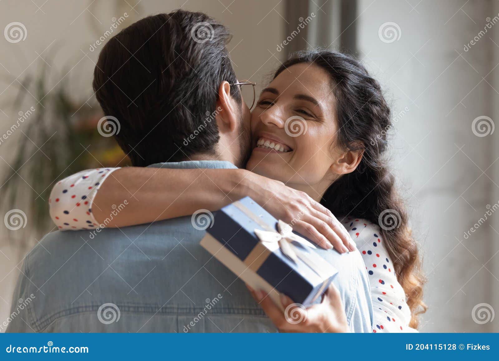 close up overjoyed young wife hugging husband, thanking for gift