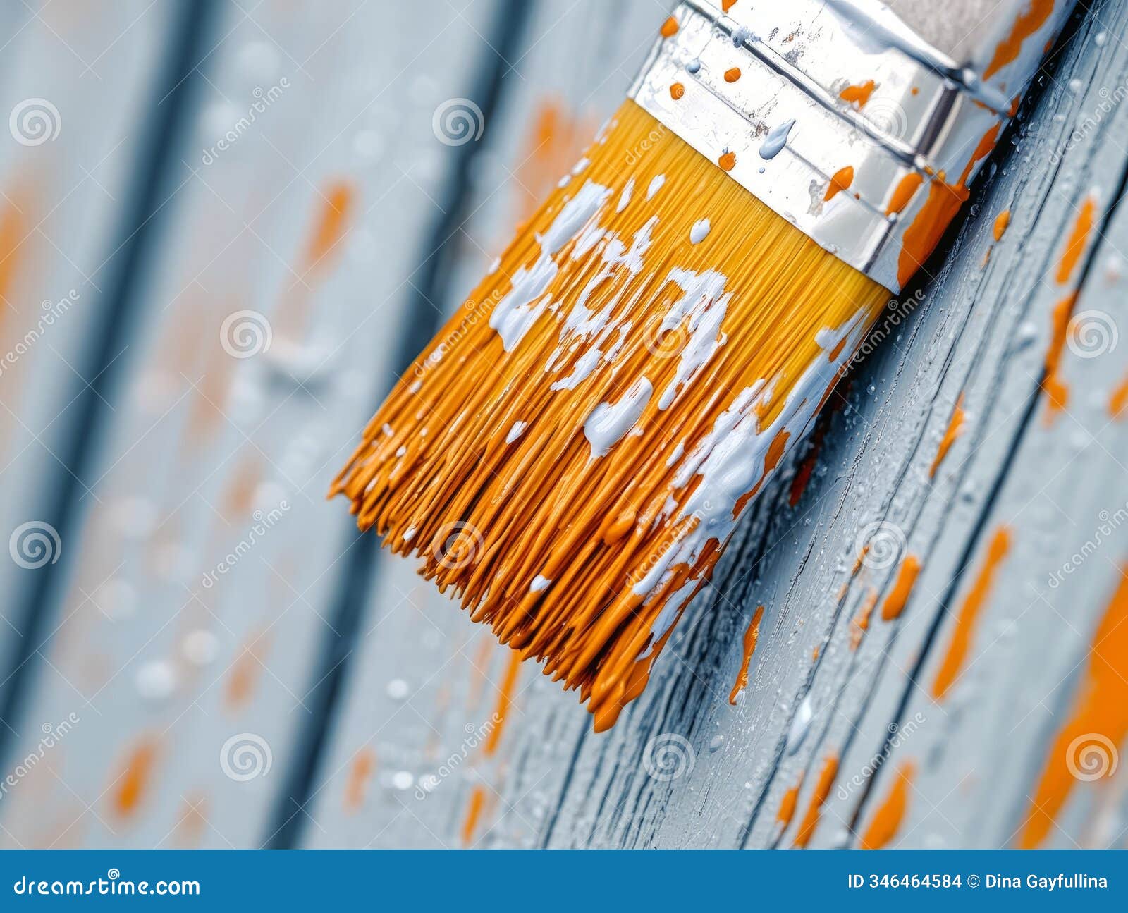 close-up of a paintbrush applying paint on wood, highlighting painting and renovation work.
