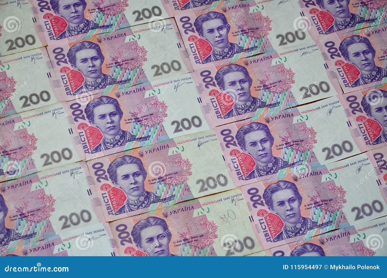 a close-up of a pattern of many ukrainian currency banknotes with a par value of 200 hryvnia. background image on business in ukr