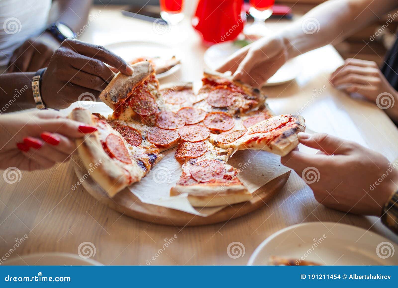 Close Up Of People Hands Taking Slices Of Pepperoni Pizza In Cafe Top
