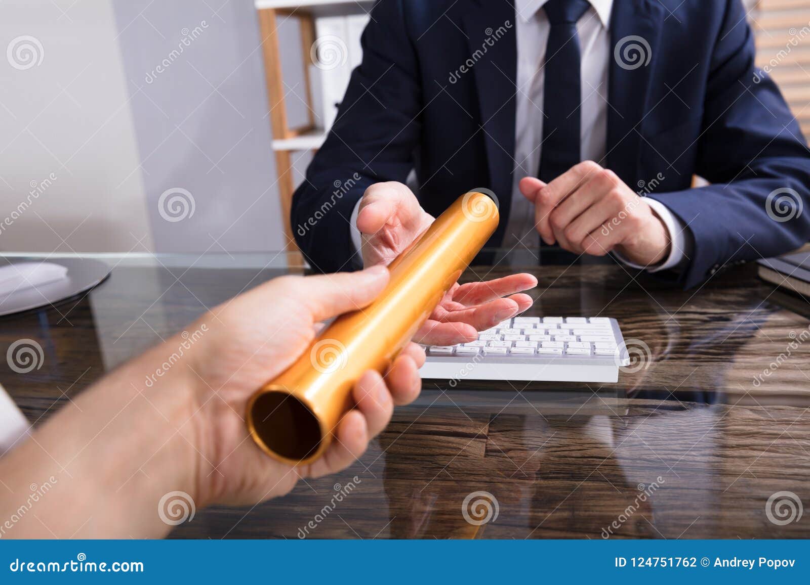 person passing baton to businessperson