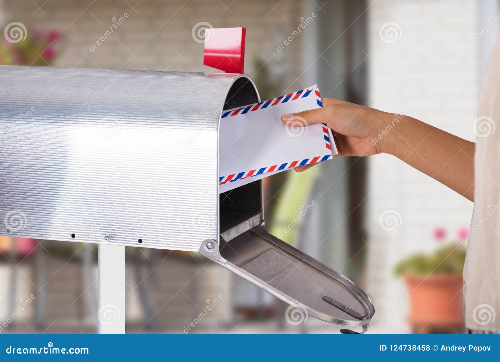 person removing letter from mailbox