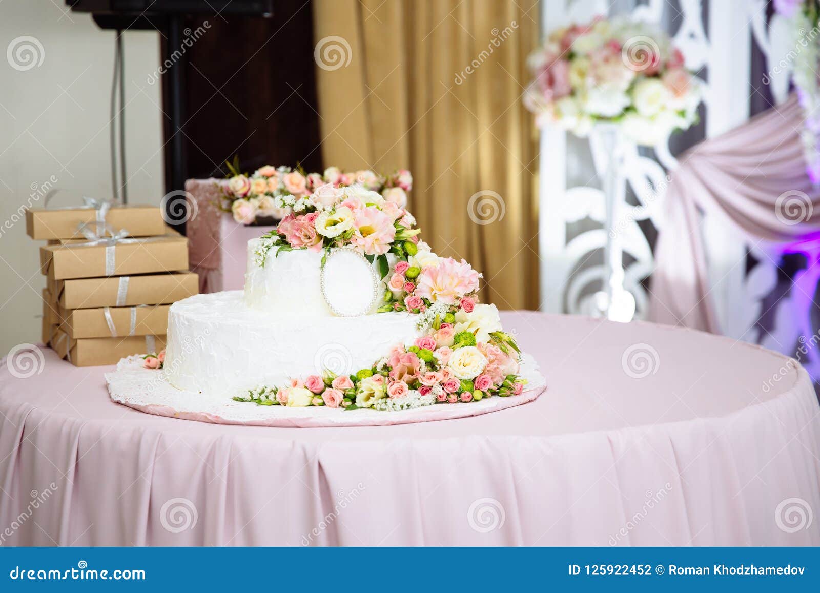 Close Up Photo Of A Wedding Cake Decorated With Fresh Flowers A