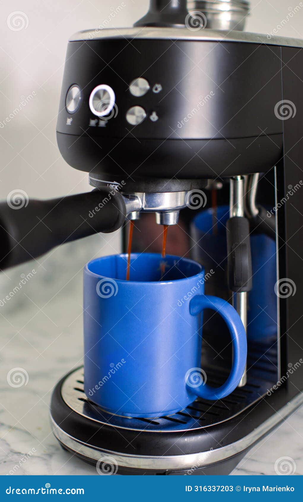 coffee extraction from the coffee machine with a portafilter pouring coffee into a cup