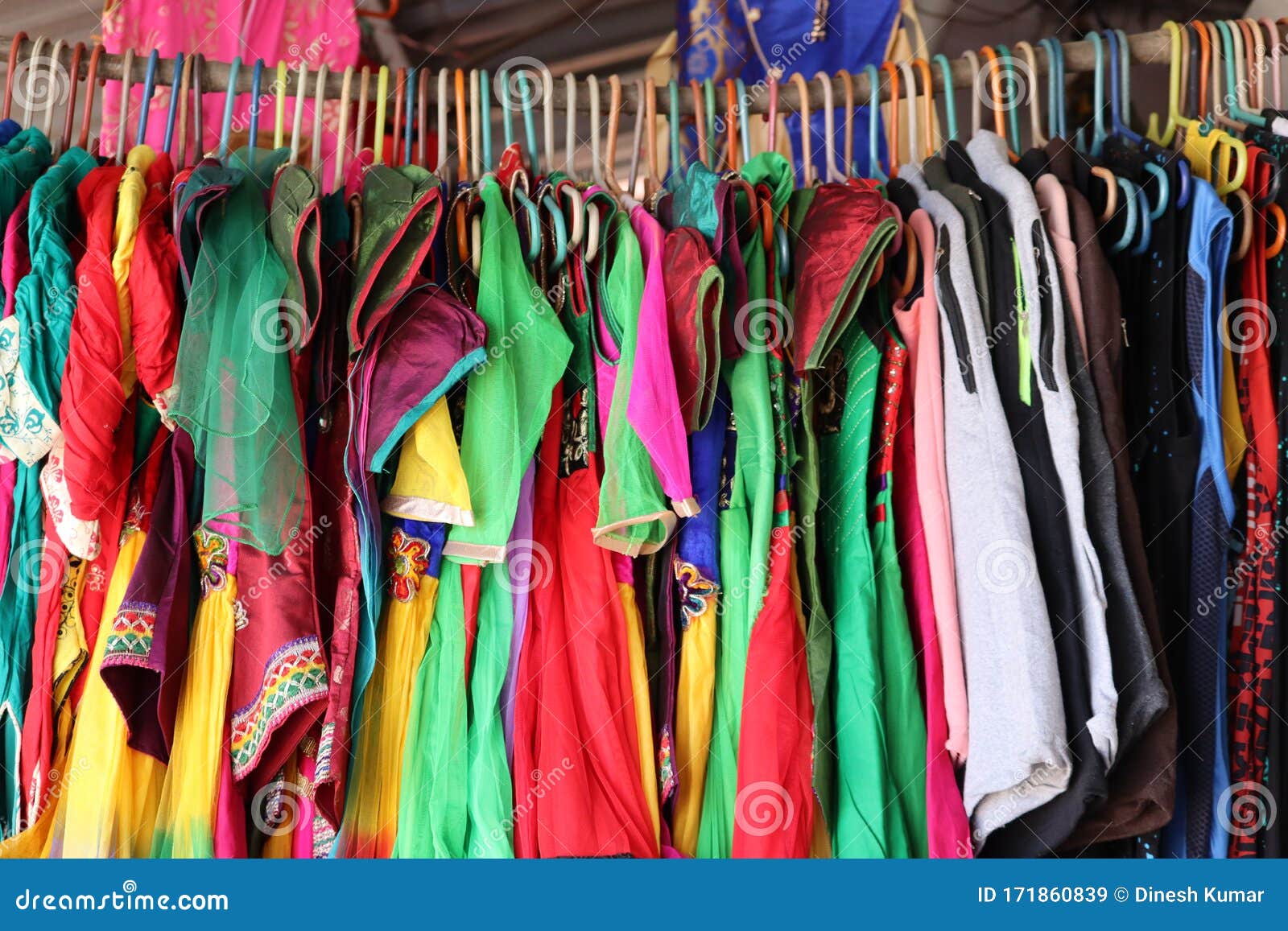 Closeup Colorful Male, Female Clothes in Boutique Hanging on