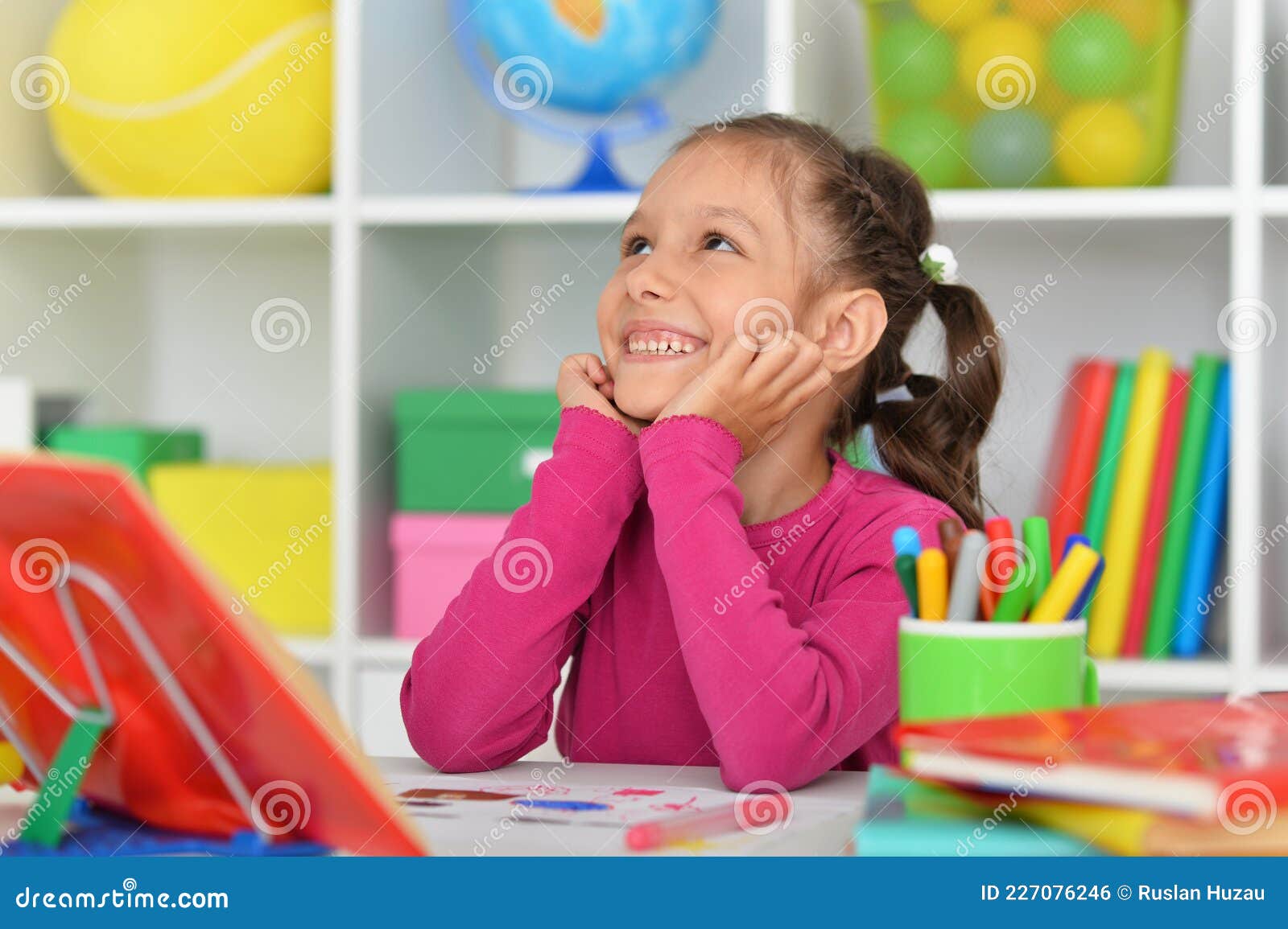 porait of cute little girl studying at home