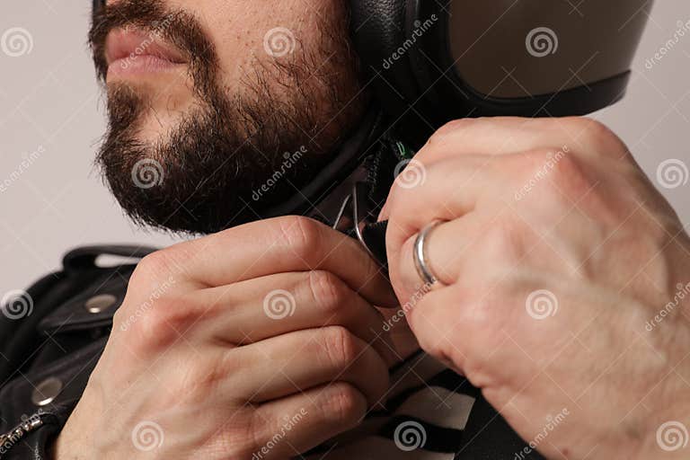 Close-up Portrait of Bearded Biker in Leather Jacket Fasten a