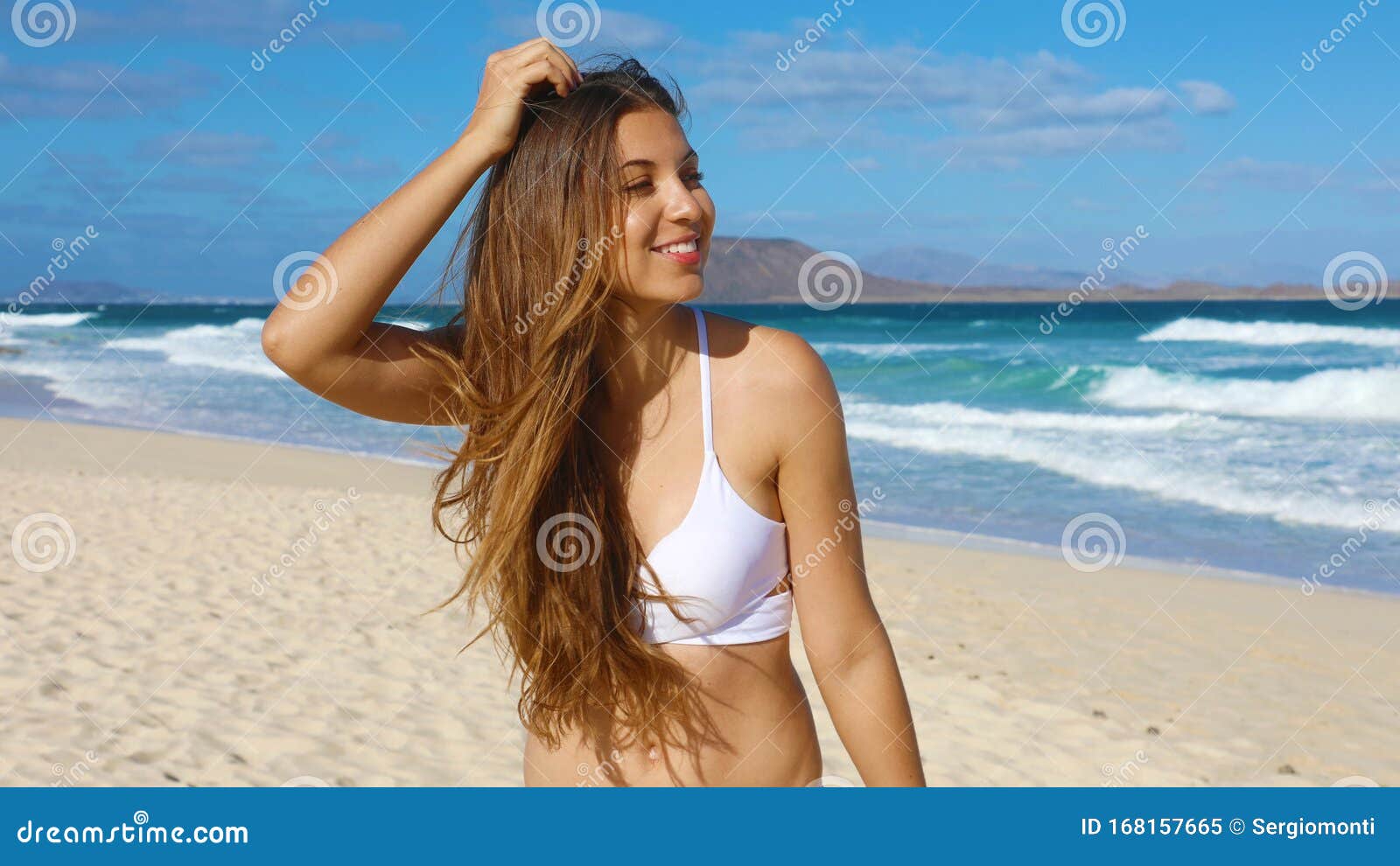close up portrait of beautiful girl have fun on corralejo dunas beach in fuerteventura, canary islands