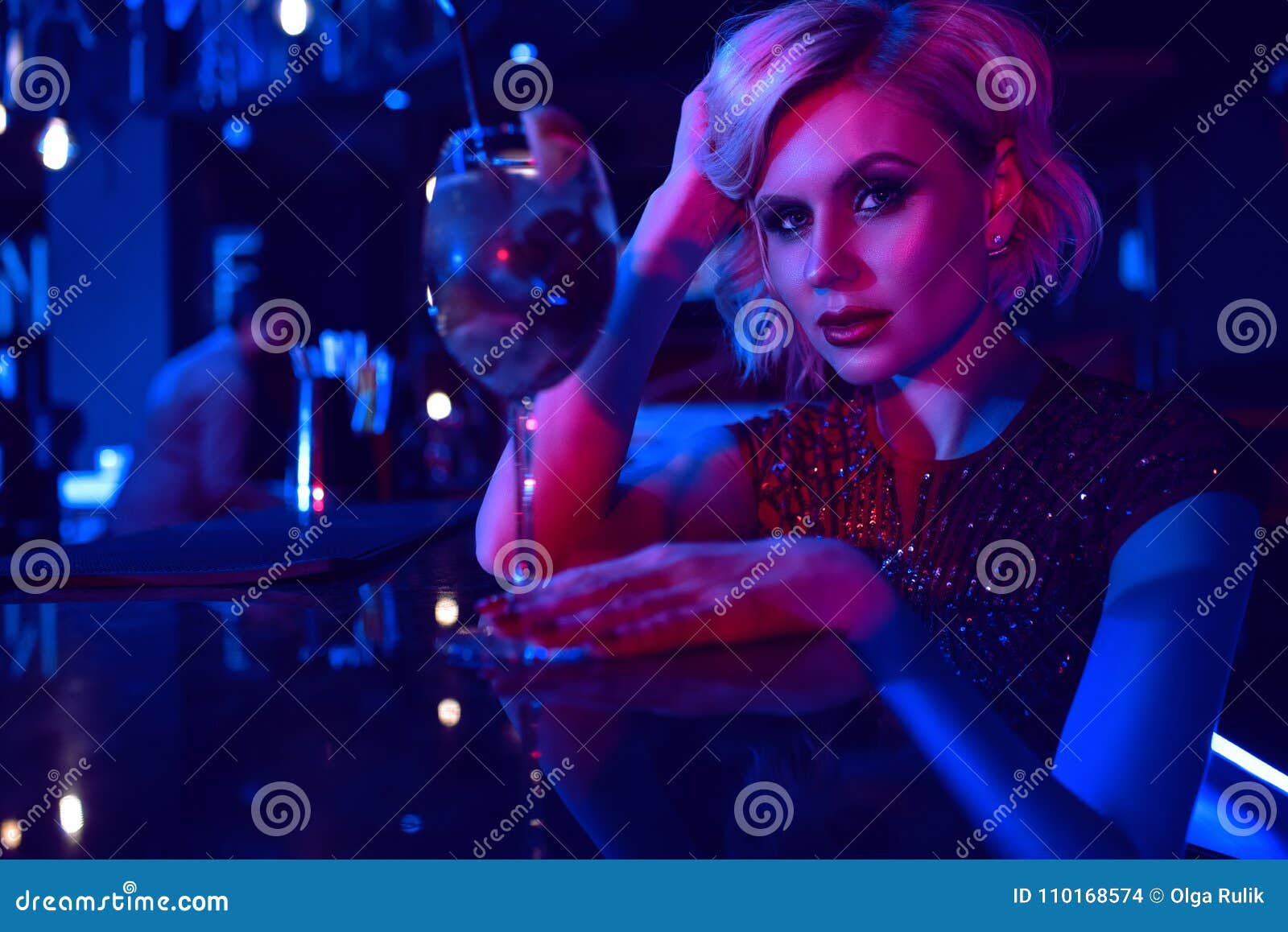 Close Up Portrait Of Beautiful Glam Blond Woman Sitting At The Bar In The Night Club In 