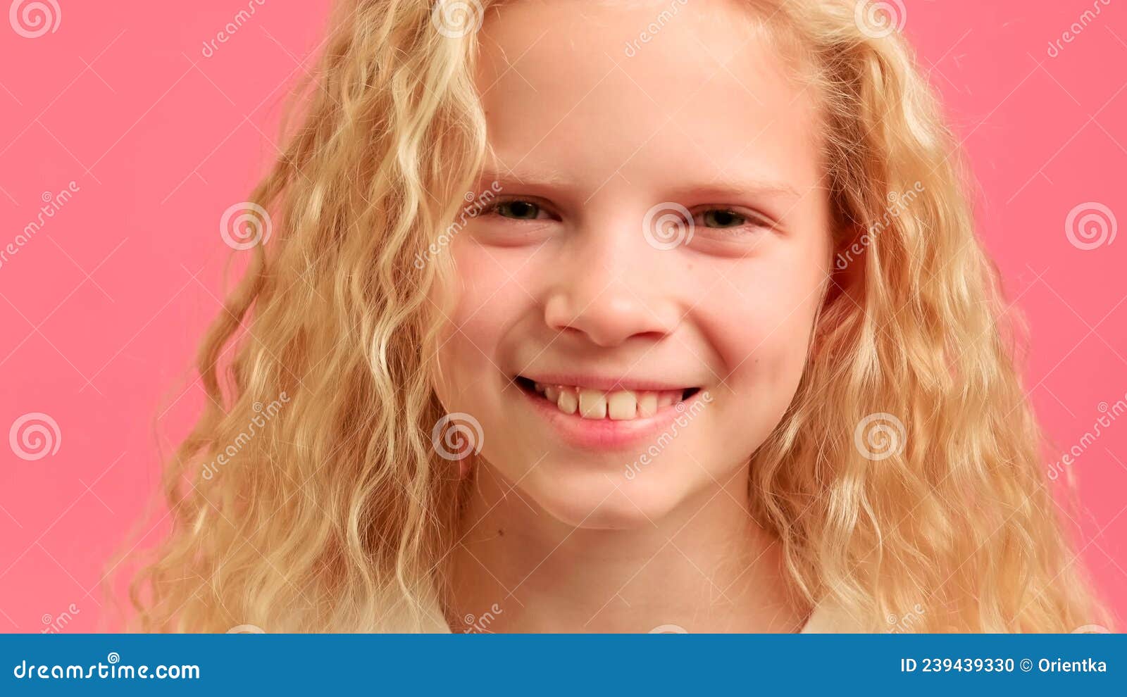 Close Up Portrait Of Blonde Teenage Girl Looks Into Camera And Smiles 
