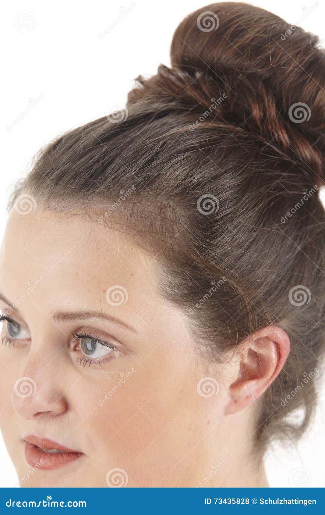 close up portrait of a brunette woman with chignon